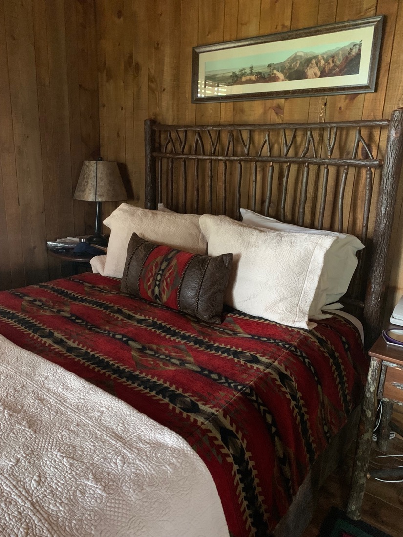 A cozy lodge bed with a woven blanket